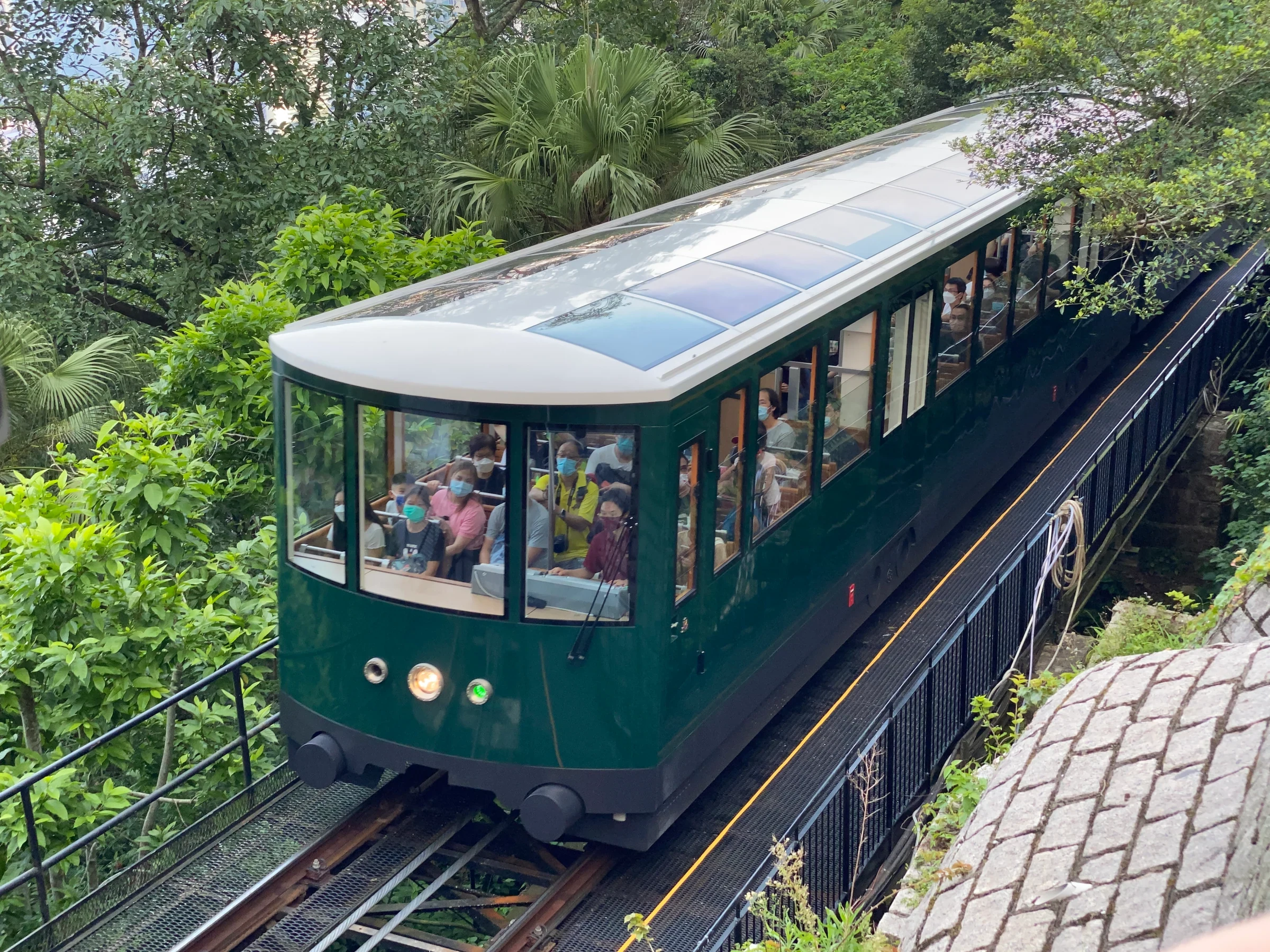 Green Peak Tram climbing a steep slope in 2022