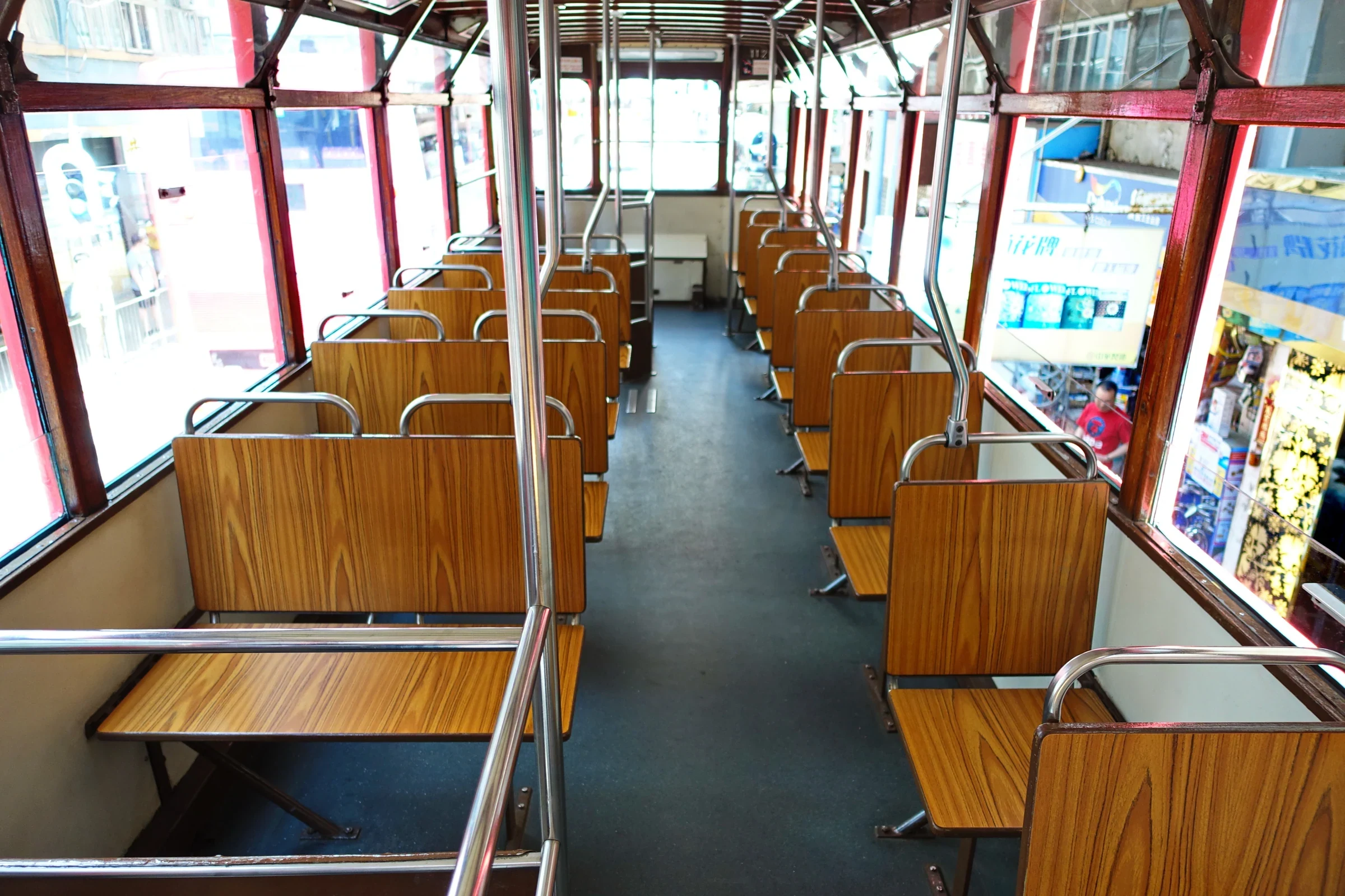 Wooden seats and windows on the upper deck of a Hong Kong tram in 2015