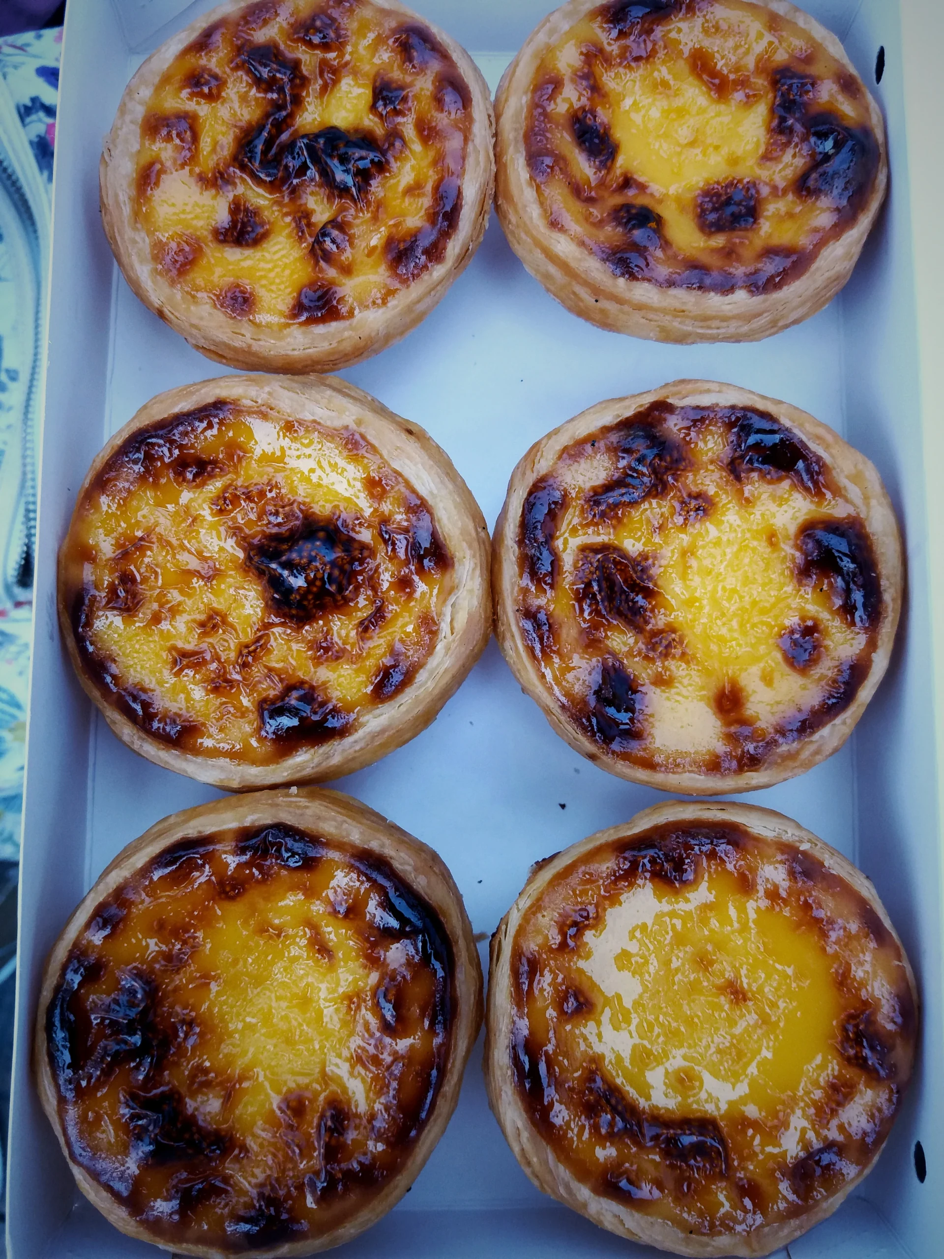 Six Portuguese egg tarts in a paper box in 2020