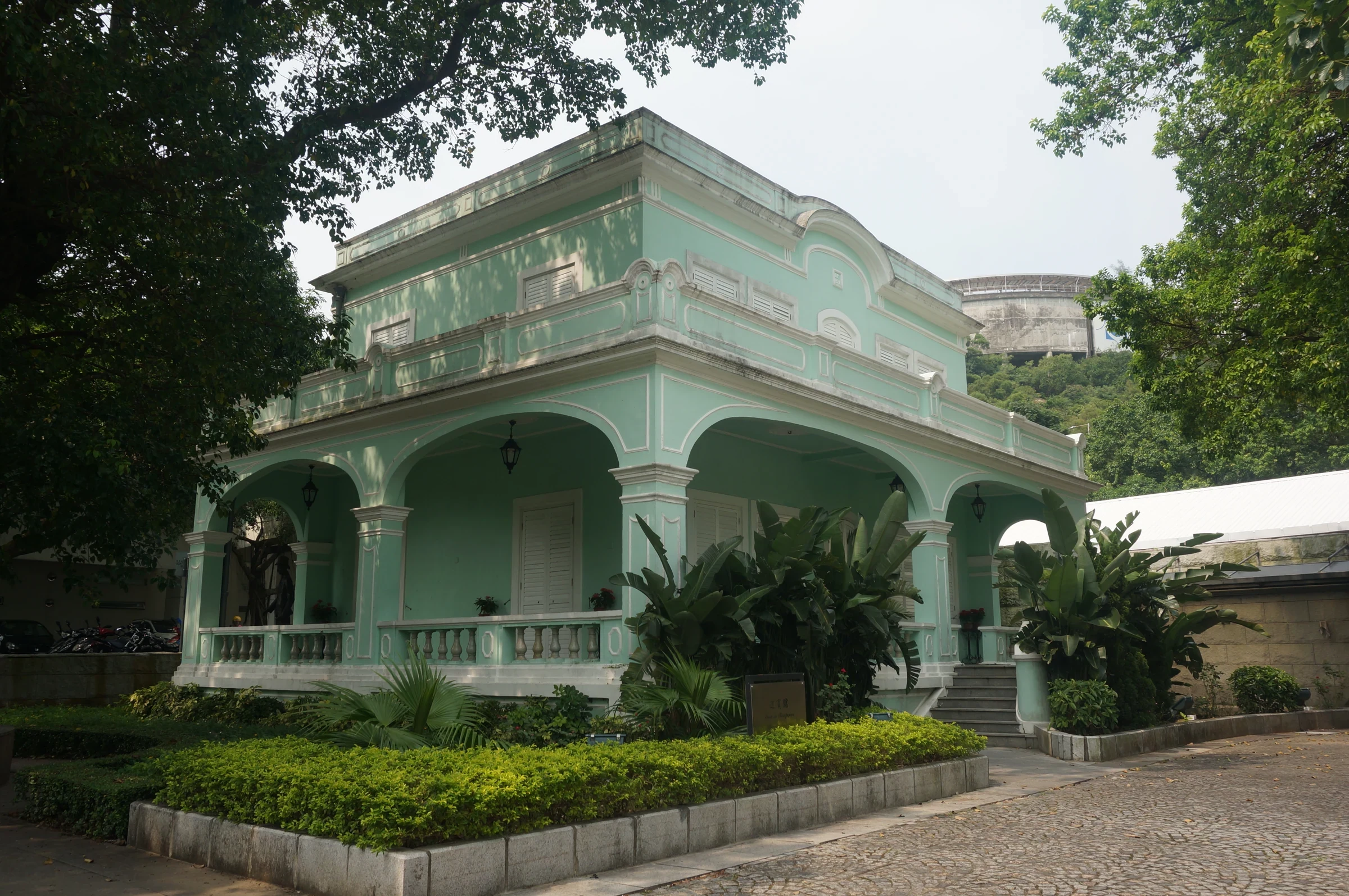 A pale green Portuguese-style Taipa Houses building in August 2019